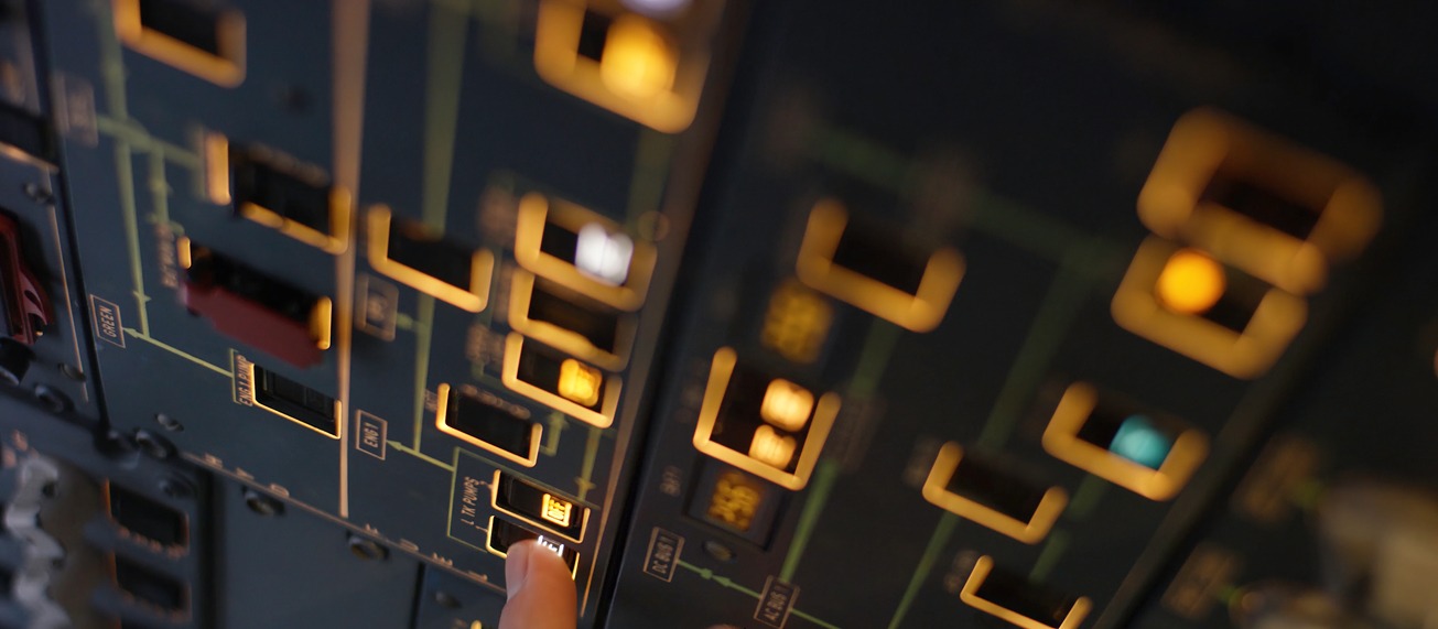 aircraft-control-panel-close-up-with-finger-on-swi